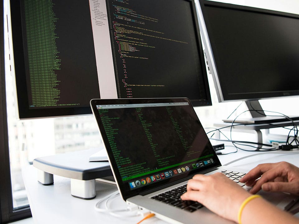 A developer using multiple screens